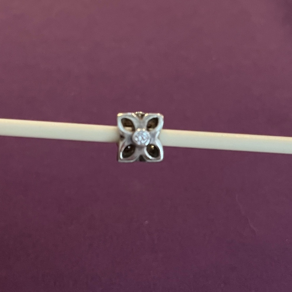 Pandora Retired Four Petal Flower Sterling silver and clear zirconia charm.